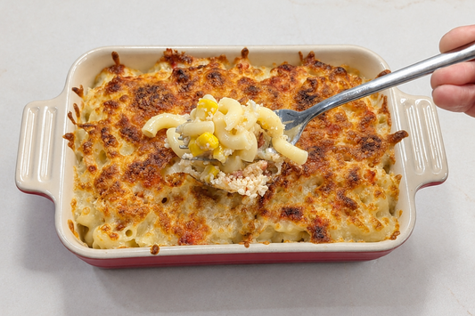Hong Kong style baked Demae Iccho cheese macaroni topped with a golden broiled Mozzarella layer and bacon in a ceramic dish