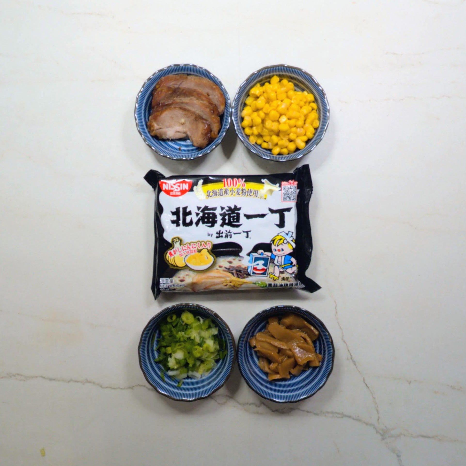 Nissin Demae Iccho 5-Pack 100% Hokkaido Wheat Flour Black Garlic Oil Tonkotsu Flavour
Black Garlic Oil Tonkotsu (Rich, Milky Pork Bone Broth) Flavor Ramen with Homemade Char Siu, Corn, Bamboo Shoots & Chopped Scallions
